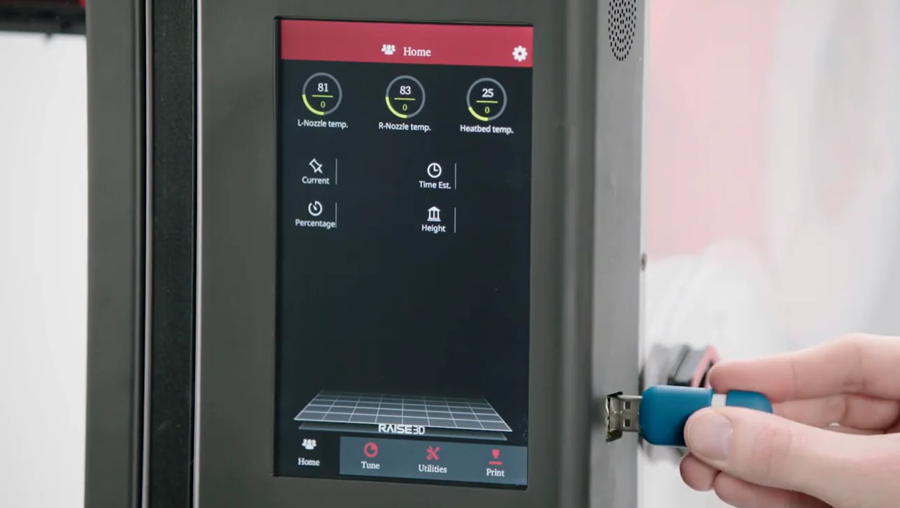 Raise3D Pro2 Plus 3D printer touchscreen panel displays settings. A hand inserts a USB drive.