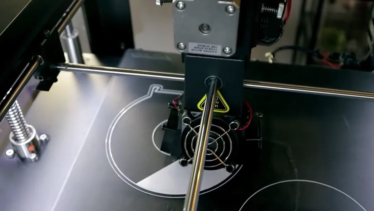Raise3D Pro2 Plus 3D printer in action, detailed view of the printing process creating complex designs on the build plate.