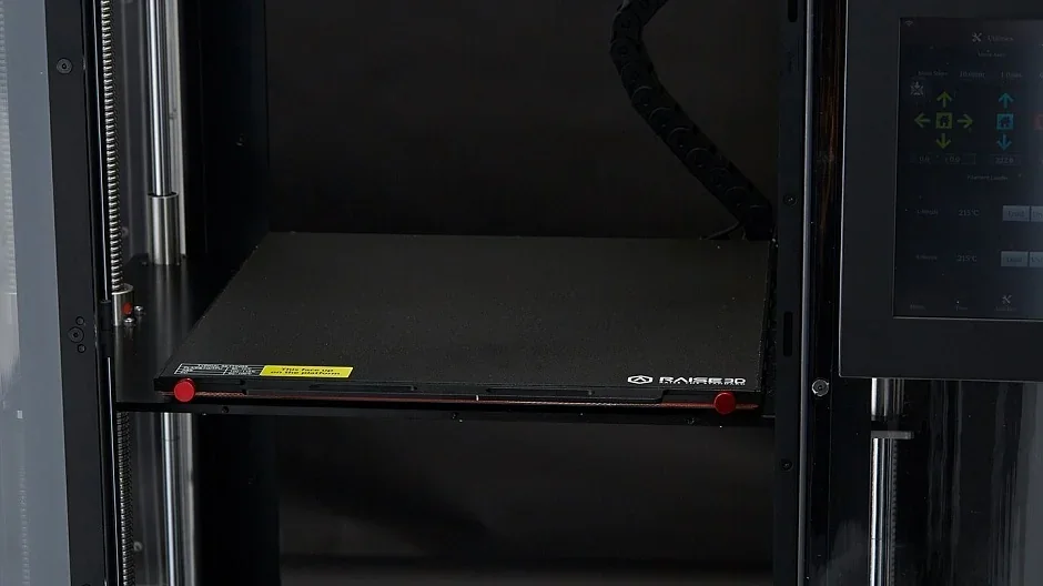 Raise3D Pro2 Plus 3D printer build platform with branding, touchscreen controls, and enclosed structure, showcasing print area for creating models.