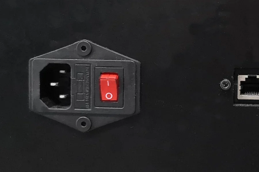 Black panel with red power switch on Raise3D Pro2 Plus 3D printer. Ethernet port visible next to switch.