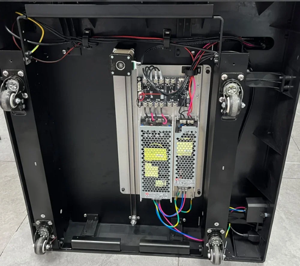 Raise3D Pro3 internal wiring and components, showing power supply, casters, and colorful cables, highlighting technical details and design.