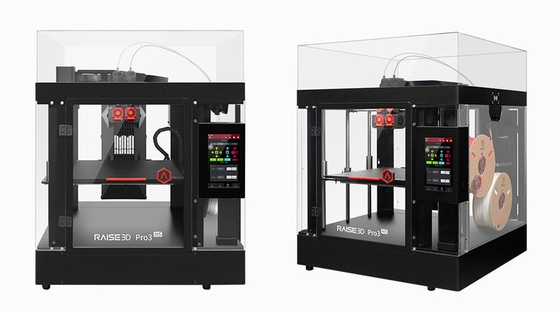 The image features two Raise3D Pro3 HS 3D printers with protective transparent enclosures. The front view of the 3D printer showcases a robust, black metal frame with a large touchscreen interface on the right side for easy control. Inside, the dual extrusion system is visible, complete with two red print heads for enhanced printing capabilities. The branding "RAISE3D Pro3 HS" is prominently displayed at the bottom front of the printer.