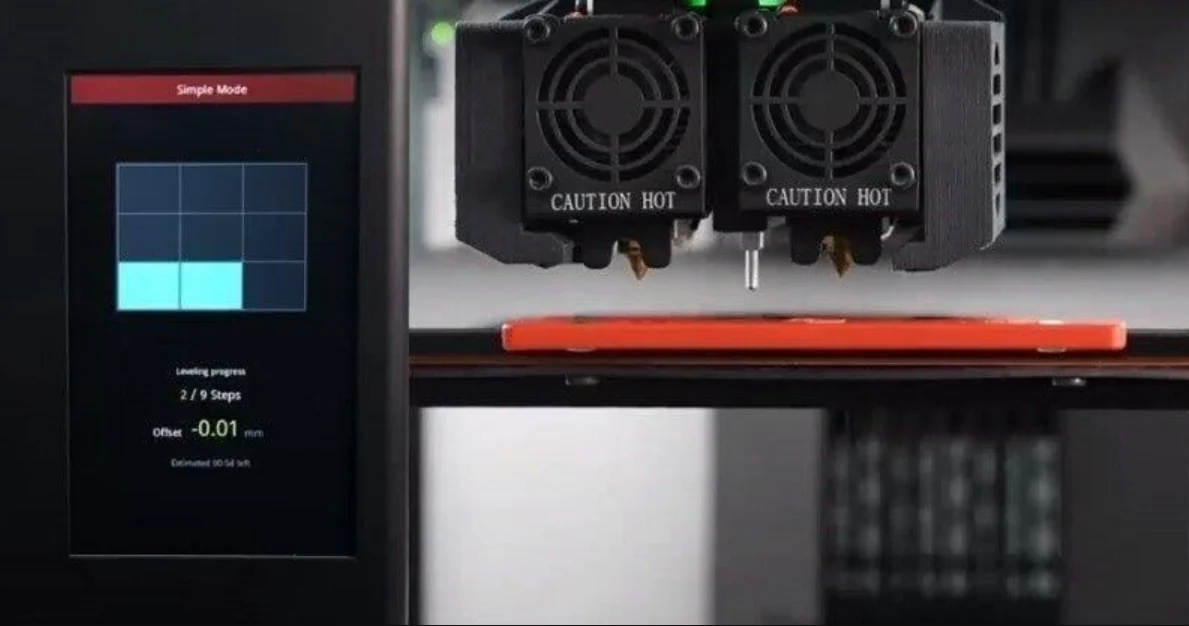 Raise3D Pro3 Plus printer with dual extruders labeled "Caution Hot," digital leveling display, actively printing on a red platform.
