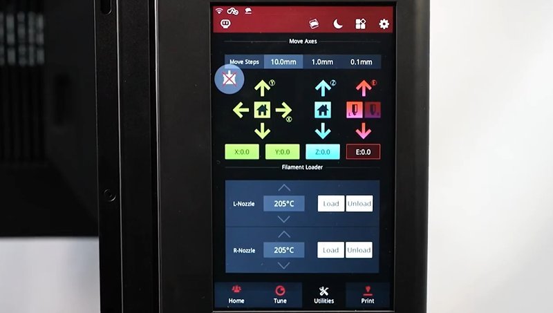 The touchscreen interface of the Raise3D Pro3 Plus HS 3D printer displays navigation and control options vividly. The screen shows various arrows for axis movement controls, options to adjust step sizes with 10mm, 1mm, and 0.1mm increments. Below, filament loader controls are visible with temperature settings for L-Nozzle and R-Nozzle, each set at 205°C, alongside options to load and unload filament. The interface is set against a sleek black frame with icons for home, tune, utilities, and print functions visible at the bottom.