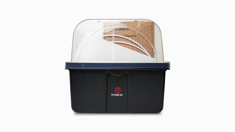 A filament dry box designed for the Raise3D Pro3 Plus HS 3D printer is presented. The black container is topped with a clear, domed lid, providing visibility of the filament inside. The Raise3D logo is prominently displayed on the front, indicating brand quality. This dry box is essential for keeping filament dry and free from moisture, ensuring optimal print quality.