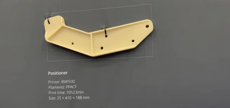 Raise3D RMF500 printed part, a beige positioner with mounting holes, detailed specs included: PPACF filament, 10h23min, 25x410x188mm.