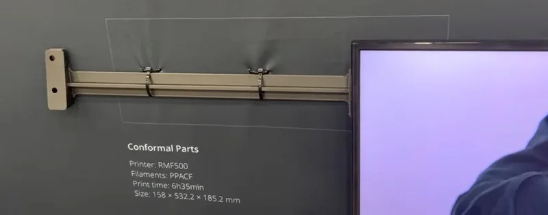 Raise3D RMF500 3D printed conformal part displayed, showcasing details like dimensions and material, with the RMF500 printer information included.
