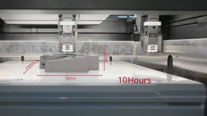Raise3D RMF500 printing a 226x210x6mm part in 10 hours, with dual extruders, inside a sleek, metallic enclosed chamber.