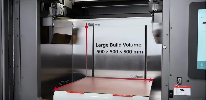 Raise3D RMF500 3D printer showcasing large build volume of 500x500x500 mm with open build chamber, highlighting its advanced industrial capability.