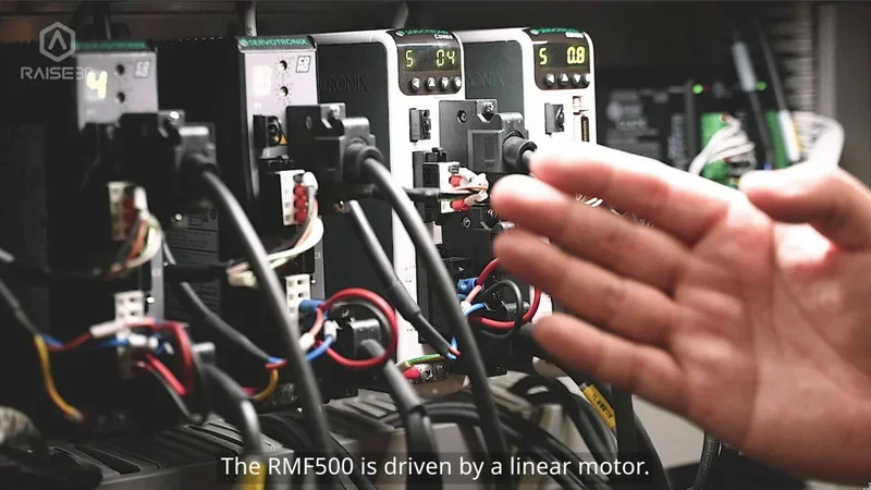 Raise3D RMF500 control system with linear motor, wiring, and digital readouts. Branding visible.