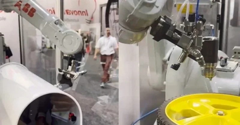 Raise3D RMF500 3D printing robotic arm in a tech expo setting, crafting a yellow wheel.