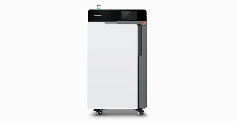 The Raise3D RMS220 3D printer features a sleek, rectangular design with a minimalist white and black color scheme. The printer has a robust, vertical structure mounted on wheels for mobility. The control panel located at the top showcases branding with the Raise3D logo, and the handle is seamlessly integrated into the design. A green status light is visible on top, enhancing the printer's modern aesthetic.