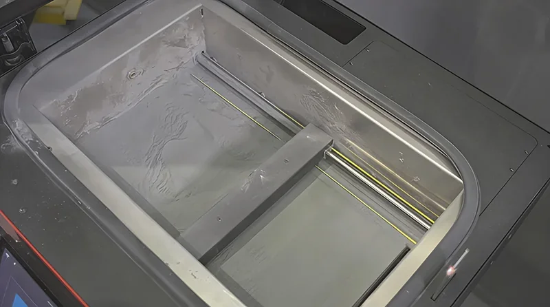 Sinterit Lisa X print bed, featuring sleek steel finish and precise detailing, designed for high-quality 3D printing with meticulously crafted samples.