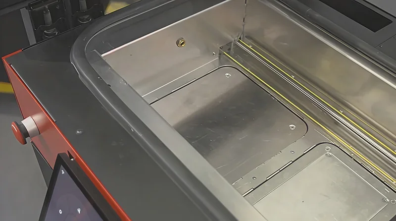 Sinterit Lisa X interior showing build chamber with metal components, designed for 3D printing objects, highlighting industrial, precise design.