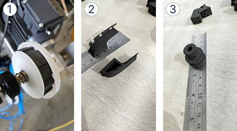 Set of black 3D-printed parts on rulers, made by Sinterit Lisa X, including a wheel, bracket, and gear on a light-colored surface.