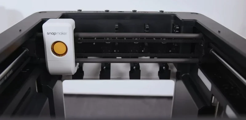 Snapmaker U1 3D printer interior with branded module, showcasing sleek design and advanced mechanics for detailed model creation.