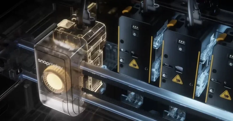 Snapmaker u1 3D printer displaying transparent components and filament loading, with intricate interior design, showcasing precision and advanced technology.
