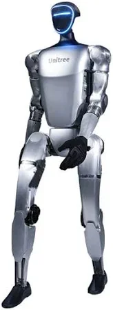 The Unitree G1 humanoid robot in an upright position. This advanced robot, designed with a futuristic aesthetic, has metallic limbs and a torso with smooth, minimalist lines. The head features a visor-like display, illuminated in blue, indicating its interactive capabilities. The branding
