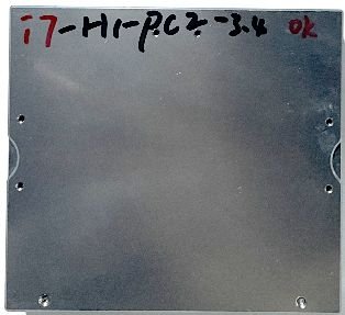 A metallic square panel with visible handwriting in black and red markers at the top. The text reads "i7-H1-PCZ-3.4" along with the text "OK" written in red. The panel has no other visible features, screws, or components.