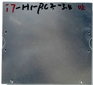 Metal panel with handwritten text "17-H1-PCZ-3.4 OK" created by Unitree H1. Five holes visible on corners and sides; industrial context.